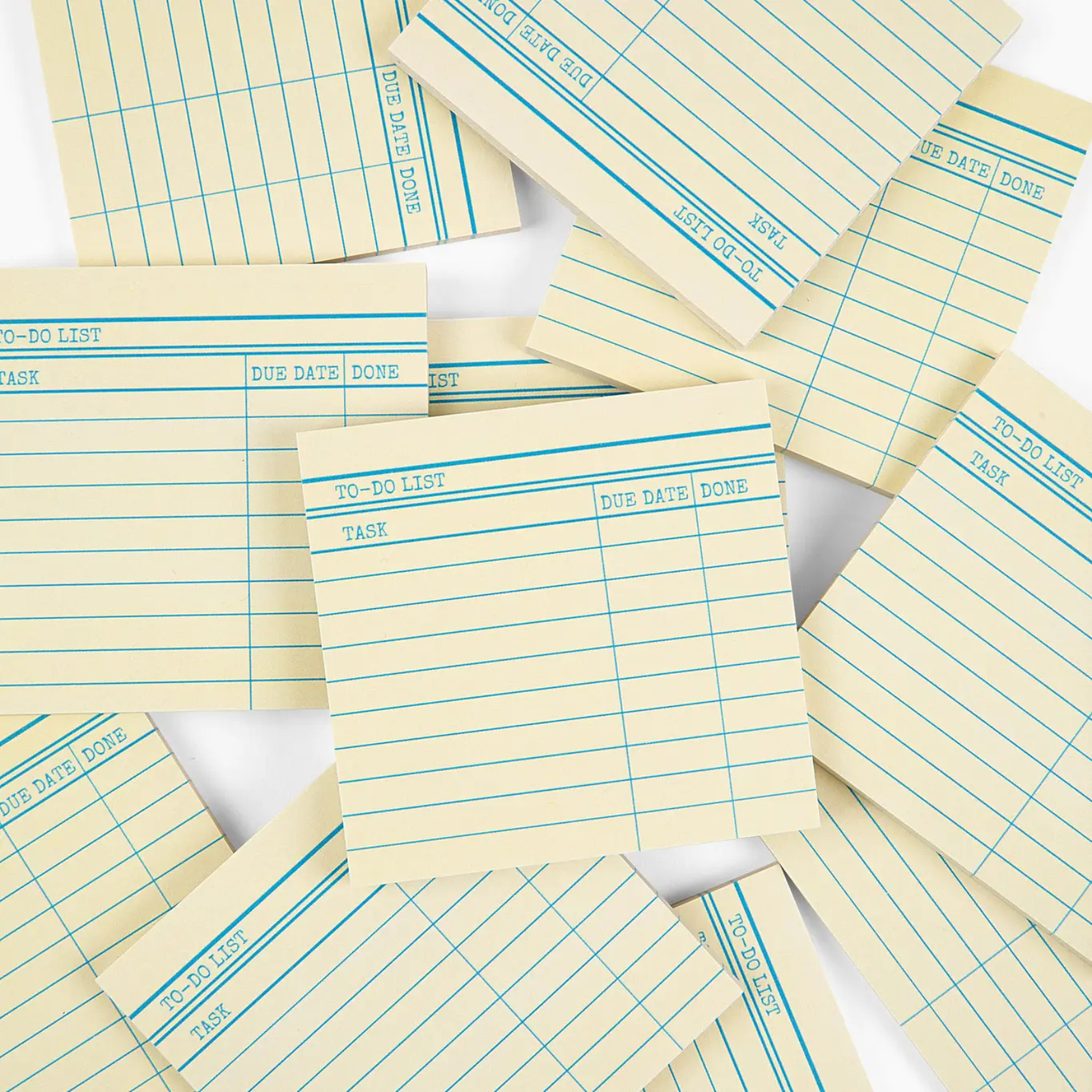 Stack of yellow lined notepads with blue lines on a white background