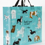 Blue Q large shopper tote. Bright blue with black, brown and white illustrations of various dog breeds. In the middle in black script reads "People I want to meet: Dogs"