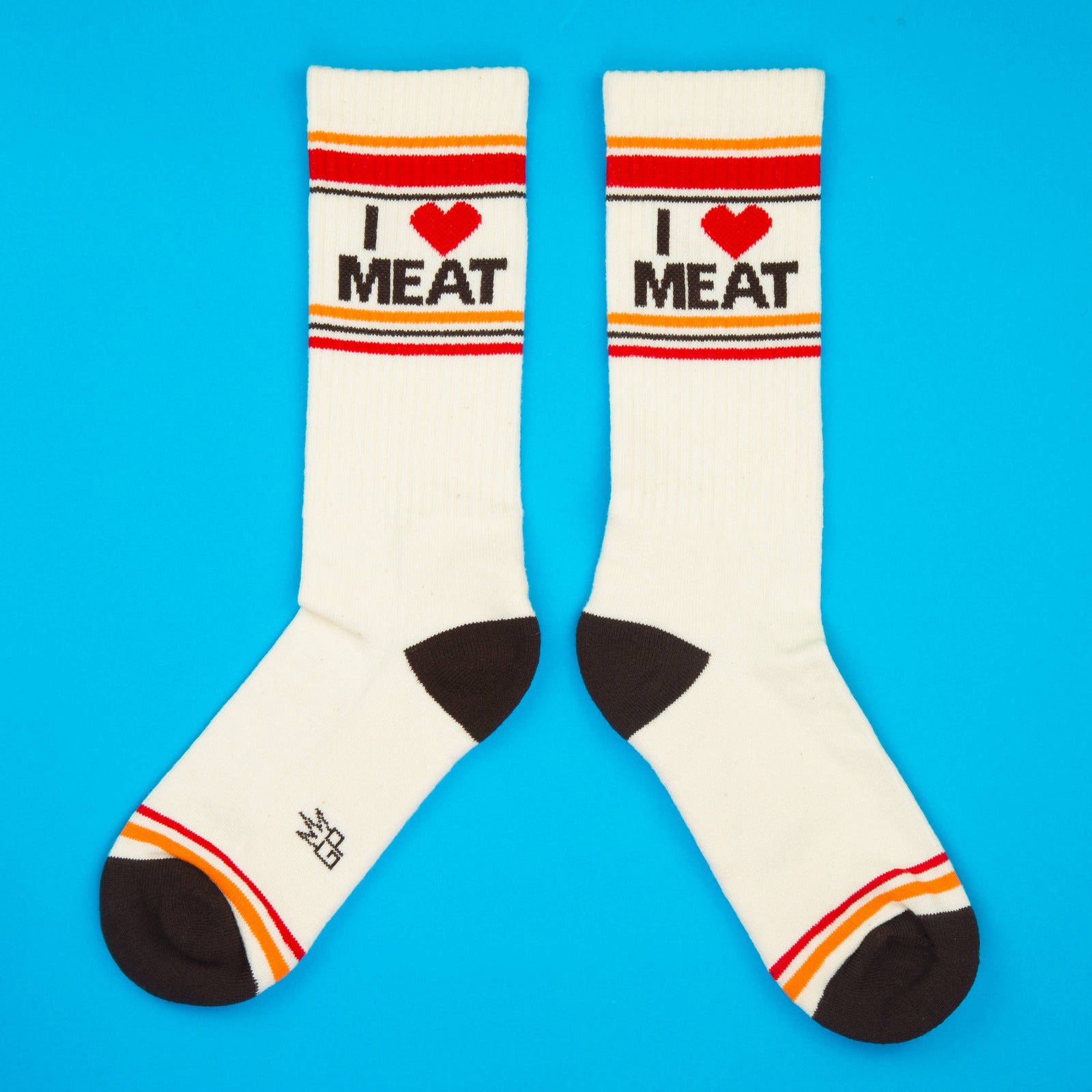 White socks with 'I ❤️ MEAT' text on a blue background