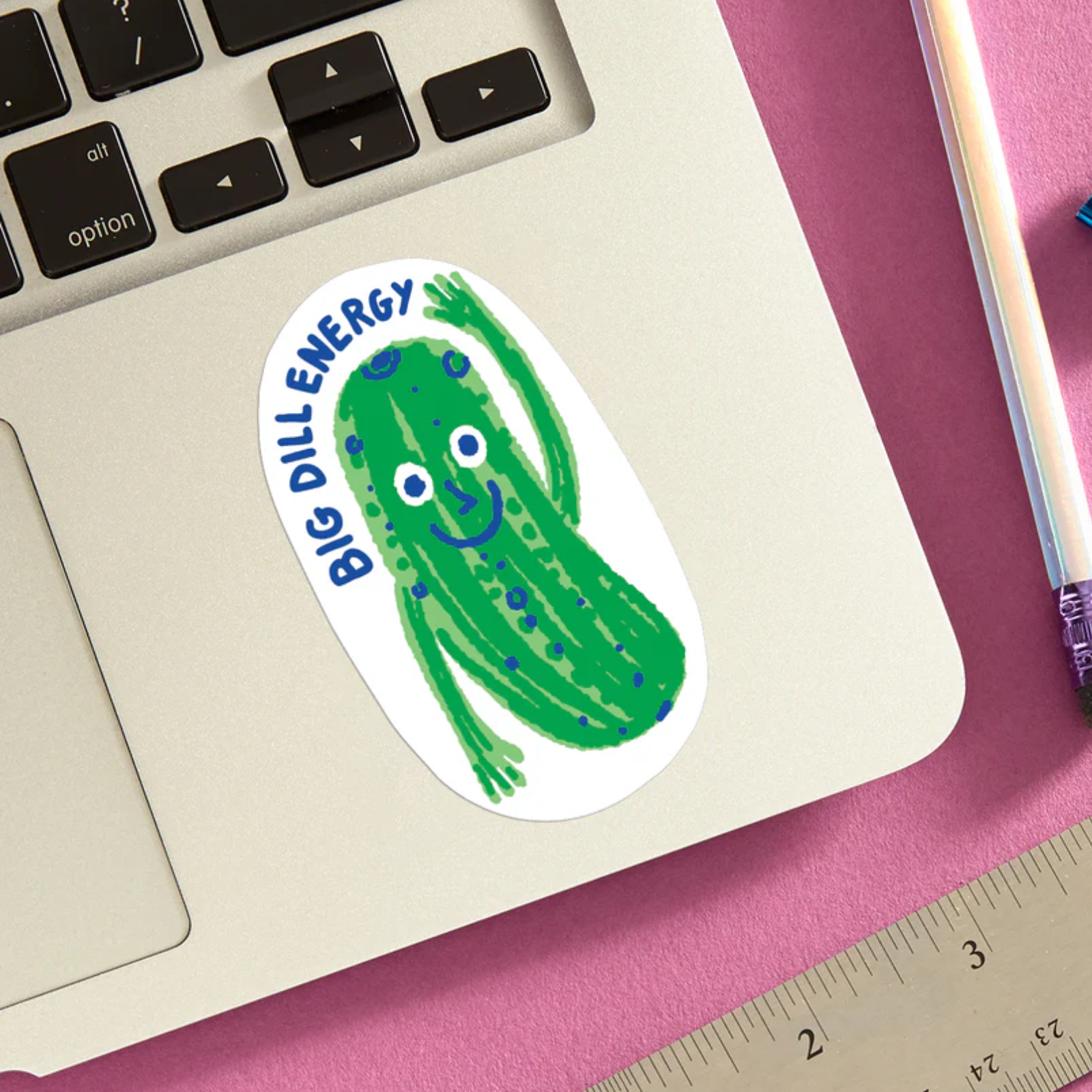 Sticker with a pickle design and 'Big Dill Energy' text on a laptop palm rest area.