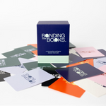 Box of 'Bonding Over Books' card game with cards spread out on a white background
