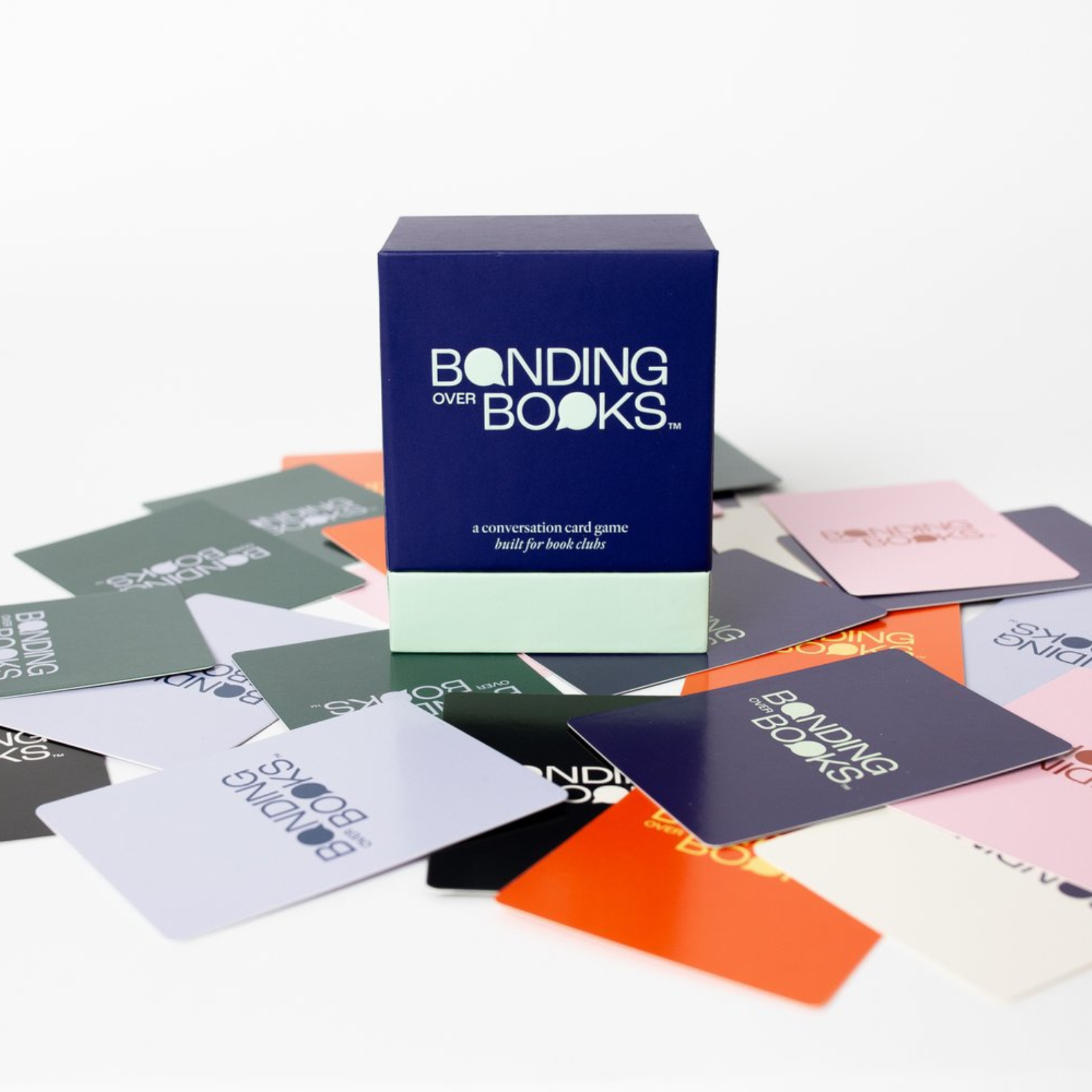 Box of 'Bonding Over Books' card game with cards spread out on a white background