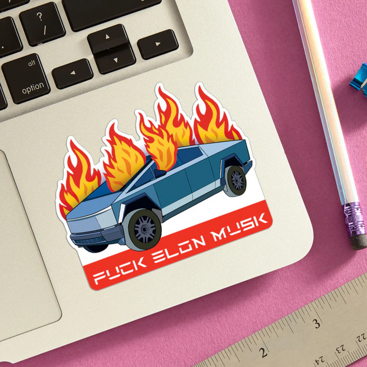 Sticker with a car on fire design and text on a laptop keyboard