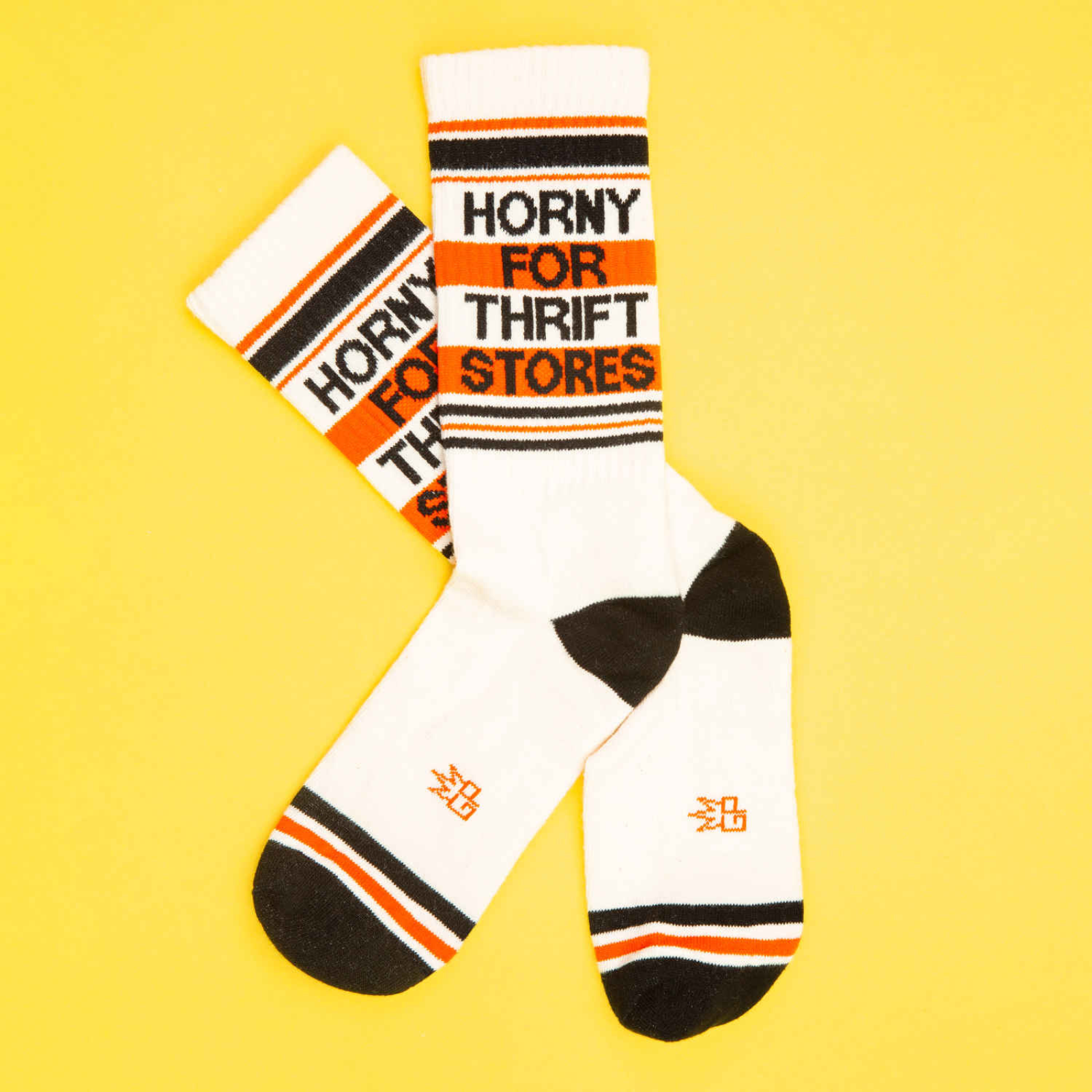 White socks with black, orange, and red text on a yellow background