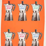 The full Blue Q towel unfolded. Bright orange with 6 screen-printed Moka Pots in two rows of 3 each. Each pot has a different accent color on the lid and writing (red, blue and green), which reads "Bitch I'm ready"
