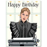 A folded A2 birthday card featuring an illustration of Taylor Swift in a black Victorian-era dress with a typewriter, with the text 'Happy Birthday' on the front.