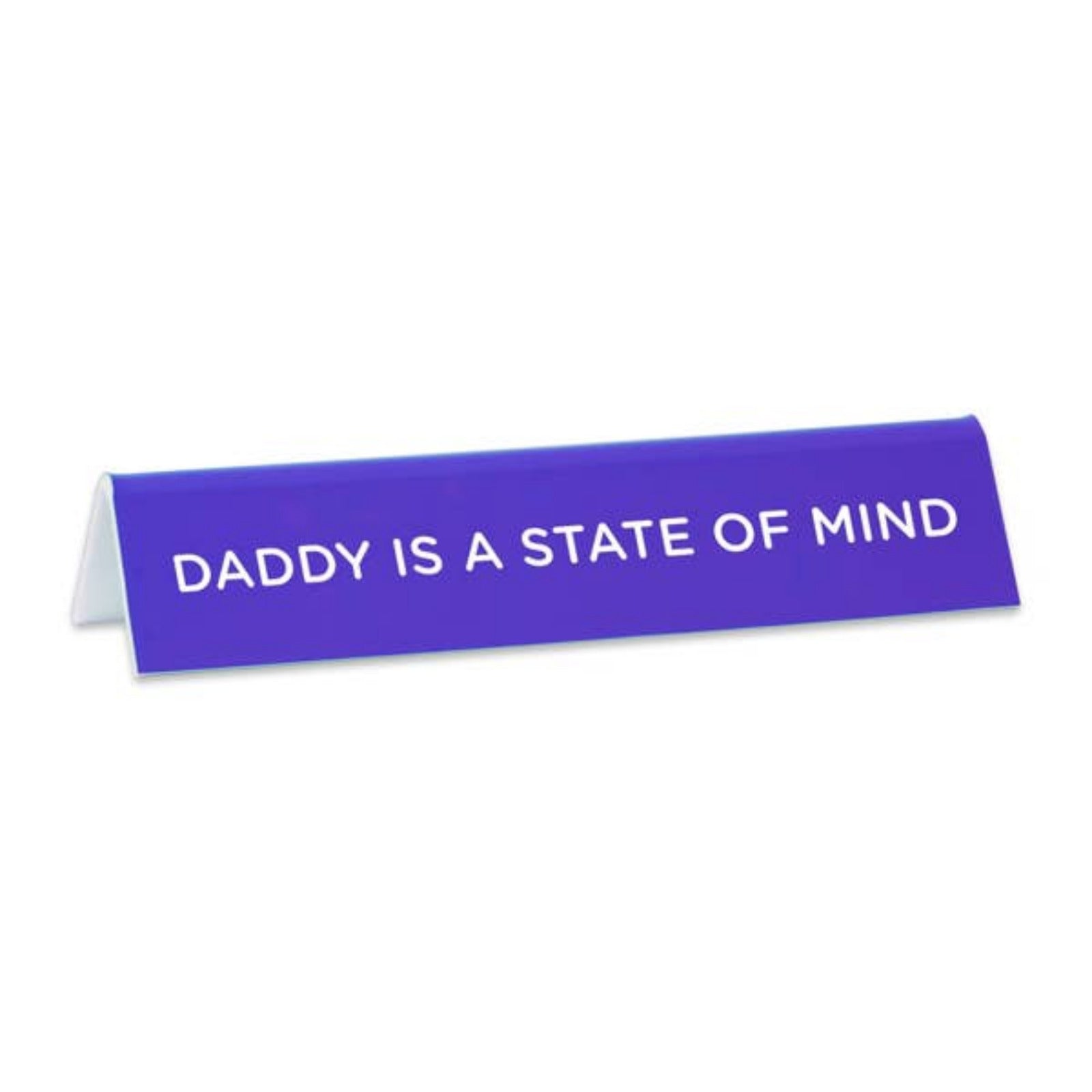 A purple desk sign with the text 'Daddy is a State of Mind' printed in white.