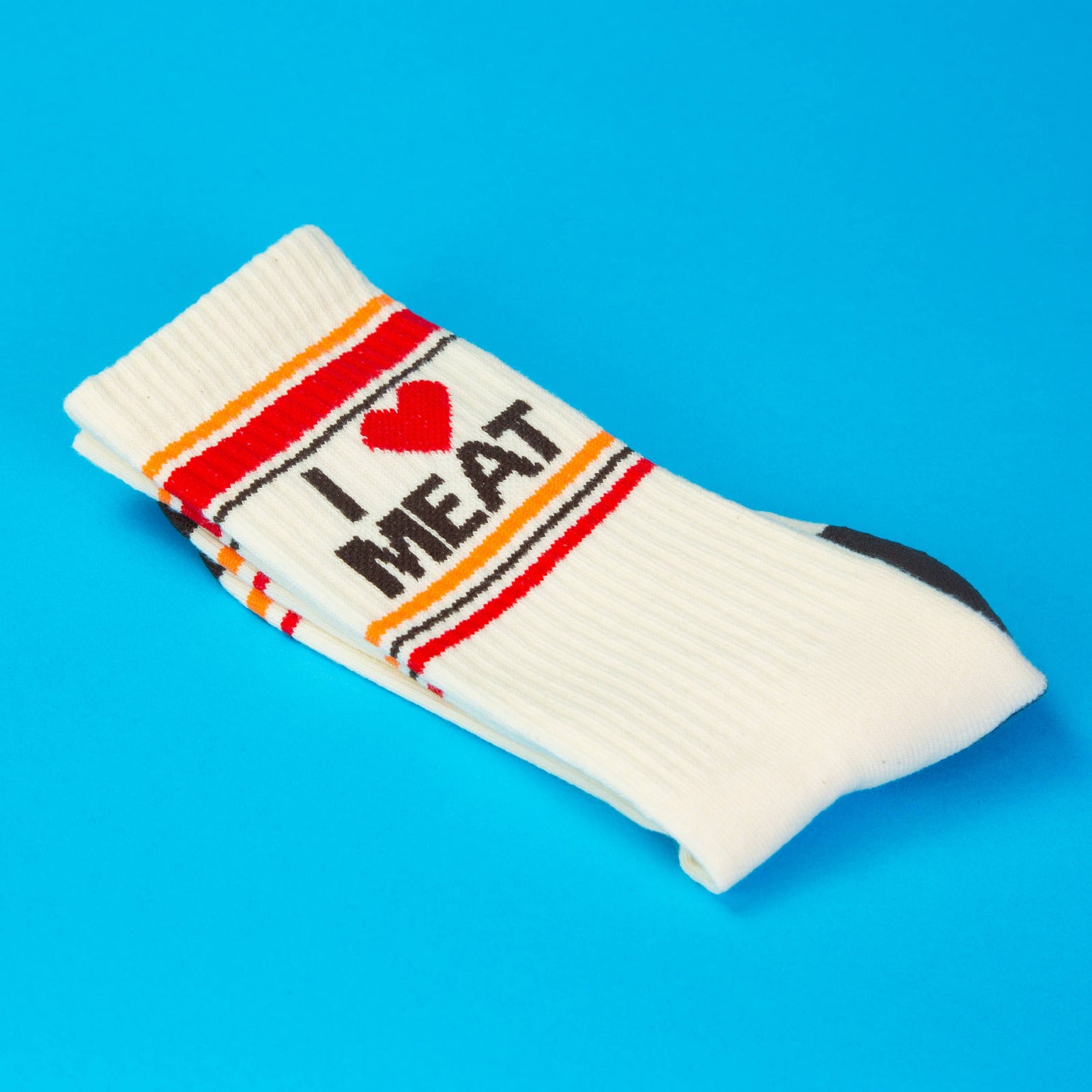 White sock with 'I ❤️ MEAT' text on a blue background
