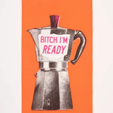 Close up of Blue Q's dish towel. Bright orange with a screen-printed Moka Pot. A pink accent on the lid as well as pink writing on the side of the pot that reads "Bitch I'm ready" 