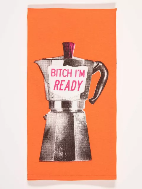 Close up of Blue Q's dish towel. Bright orange with a screen-printed Moka Pot. A pink accent on the lid as well as pink writing on the side of the pot that reads "Bitch I'm ready" 