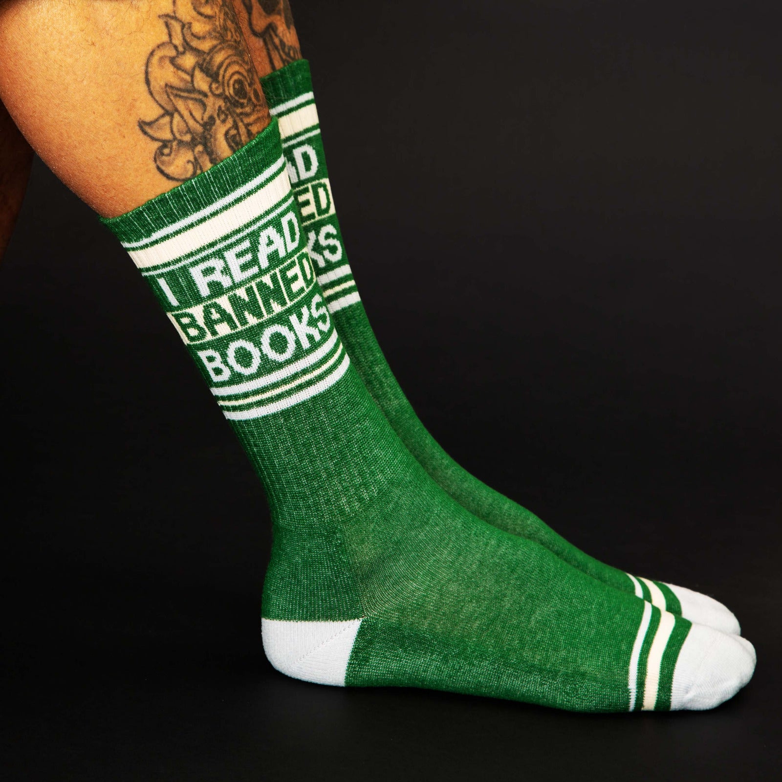 Green sock with text 'I Read Banners Books' on a black background