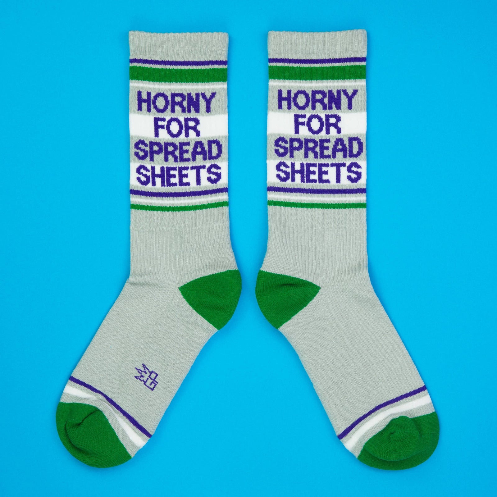 Gray socks with text that reads "Horny for Spread Sheets" and green accents on a blue background