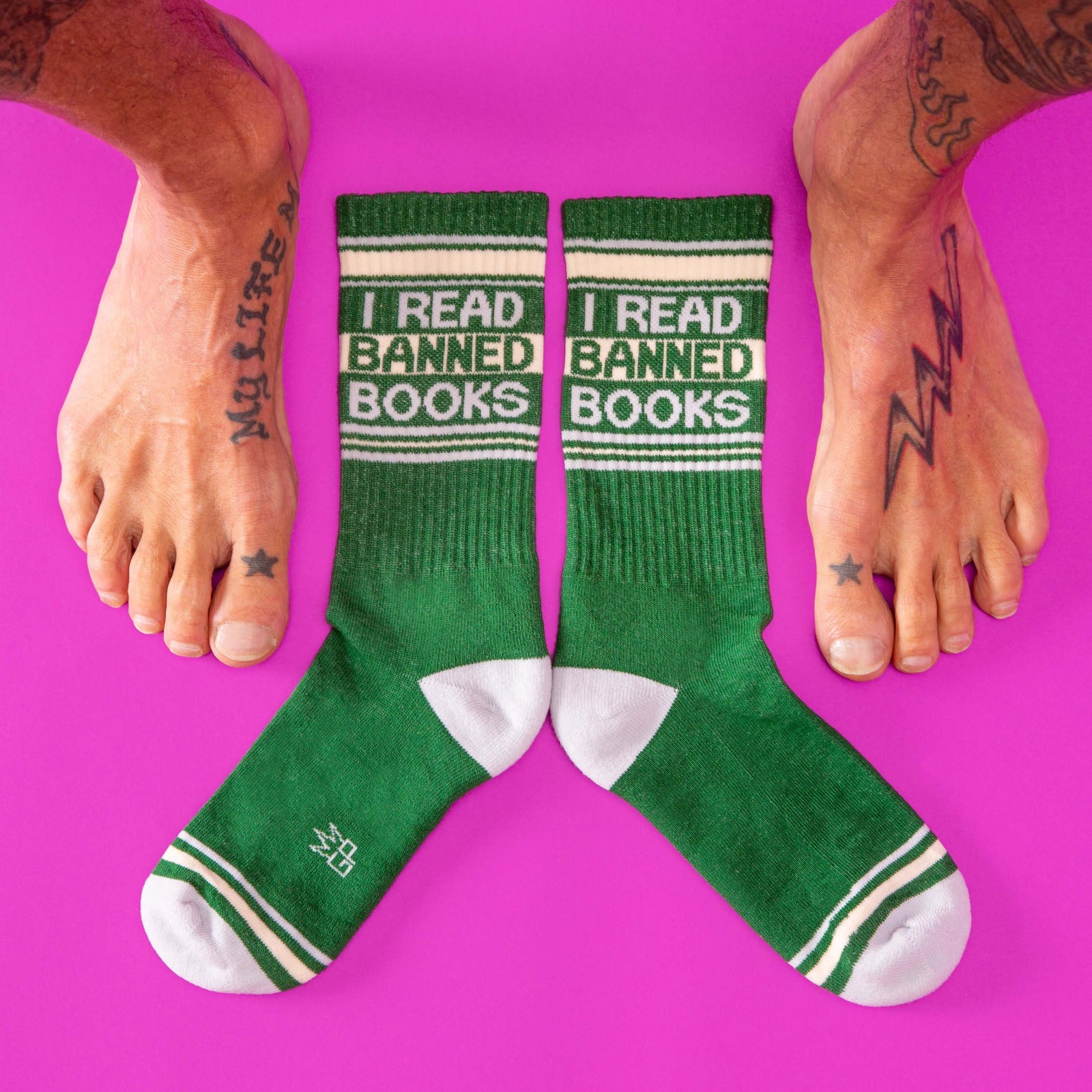 Green socks with 'I Read Banned Books' text on a pink background