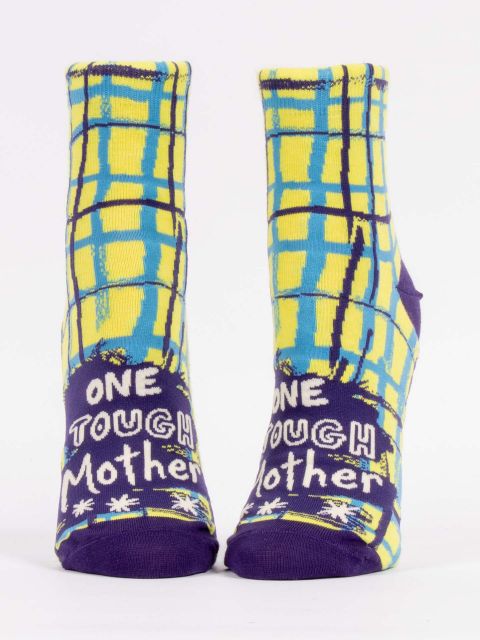 Blue Q crew socks. Bright yellow with a light blue and navy blue plaid pattern over top. On the top of the foot in white letters reads "One tough mother" 