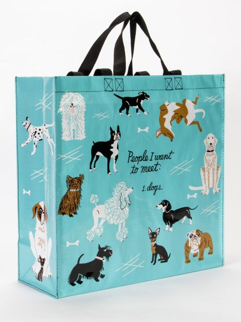 Blue Q large shopper tote. Bright blue with black, brown and white illustrations of various dog breeds. In the middle in black script reads "People I want to meet: Dogs"