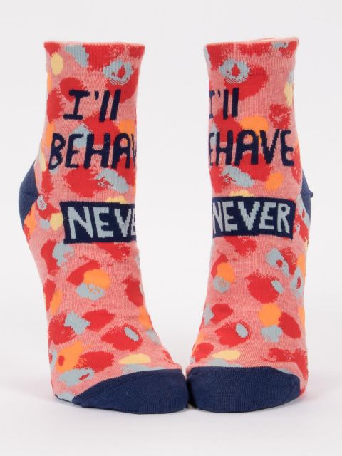 Blue Q crew socks. Salmon colored background with red, orange, blue and yellow splattered organic dots all over. In navy writing it reads "I'll behave Never"