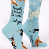 Blue Q crew socks, Light blue with illustrations of different breeds of dogs (a corgis, chihuahua, dauchaund, bull dog, poodle). In black script it reads "People I want to meet: Dogs"