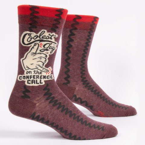 Blue Q crew socks. maroon with a red stripe at the top. An illustration of a hand giving the shaka symbol is in the middle of the words "Coolest guy in the conference call"