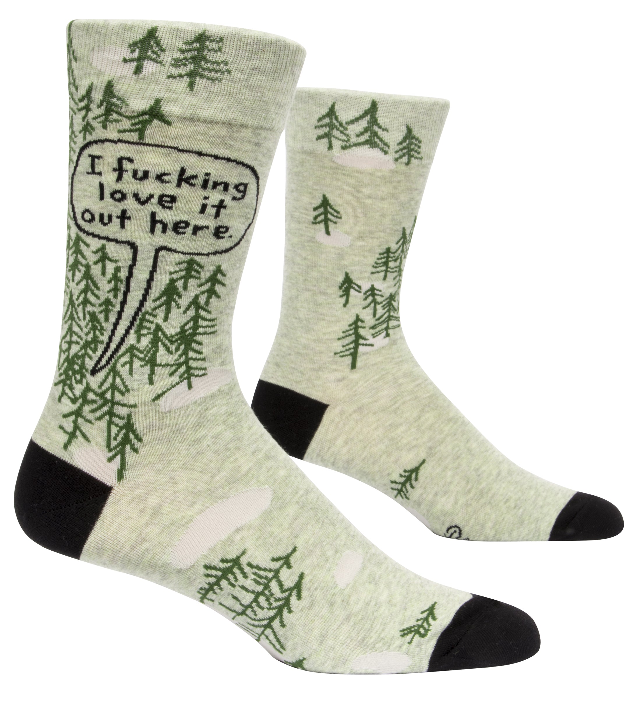 Blue Q crew socks. Light green with black heel and toe. Simple dark green pine tree illustrations dot the upper portion of the sock, a few scattered on the bottom portion of the sock. In a black outlines speech bubble on the top of the sock are the words "I fucking love it out here."