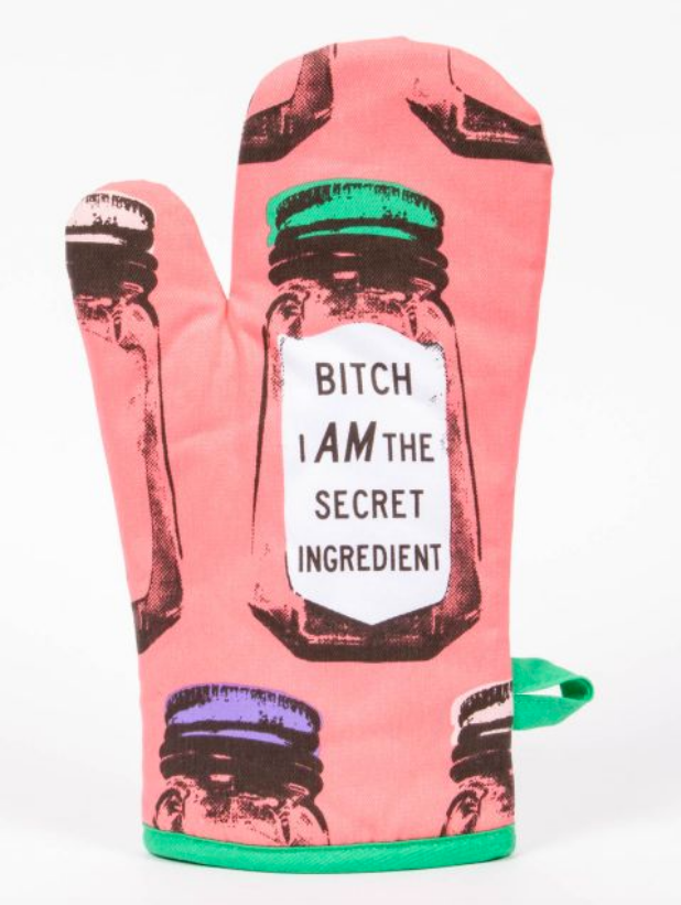 Blue Q's Hot pink oven mitt with bright green trim on the wrist and green accents. It features an image of a glass spice jar with a green lid. The label of the spice jar reads "Bitch I am the secret ingredient"