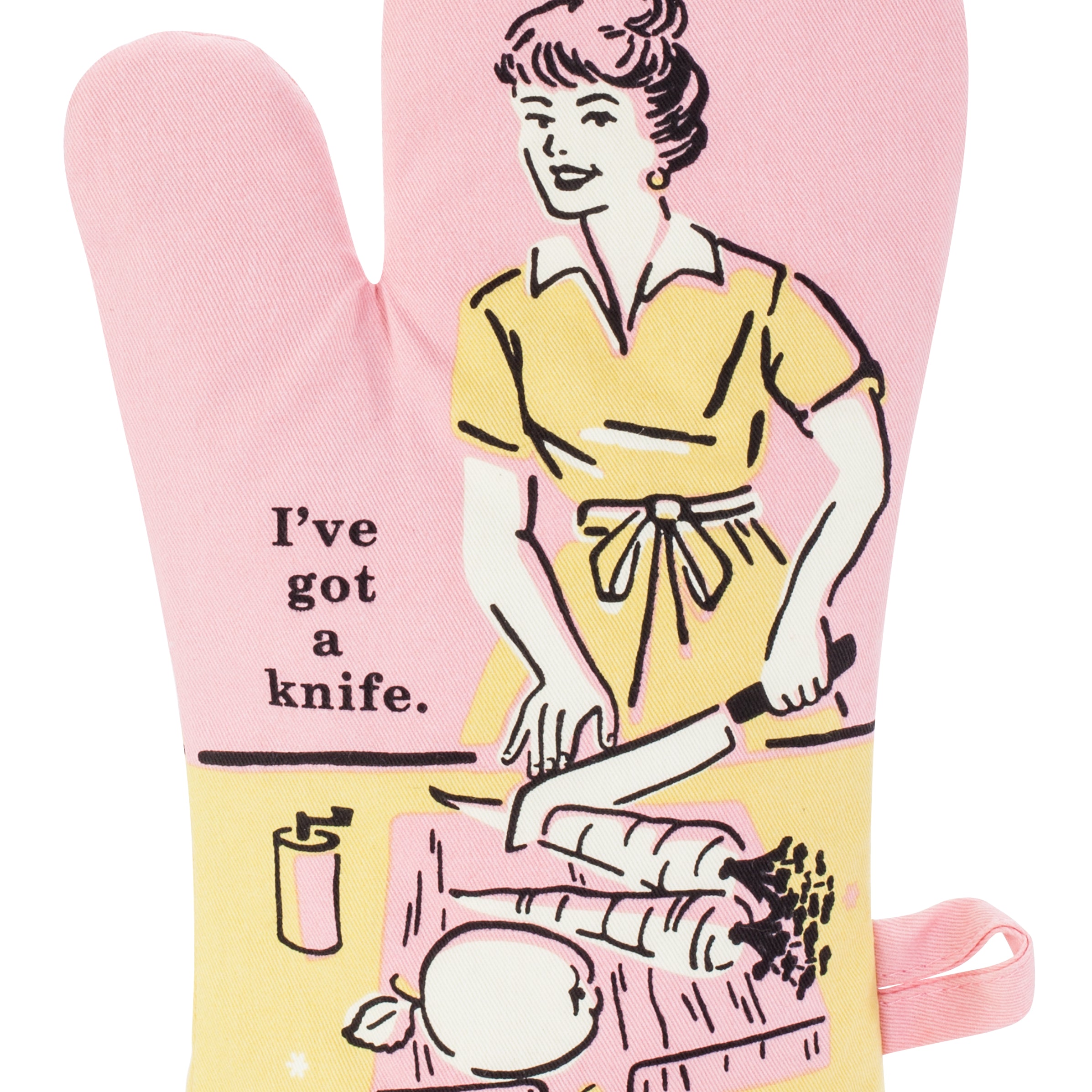 Blue Q oven mitt. Pink, yellow and black illustration of a women cutting up carrots and an apple. Next to her text reads "I've got a knife"
